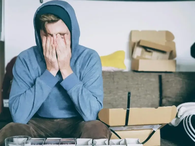 man-with-his-hands-over-his-face
