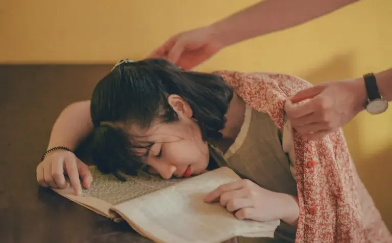 a woman sleeping on a book